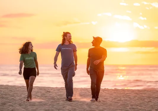 Backroads guests on the beach at sunset