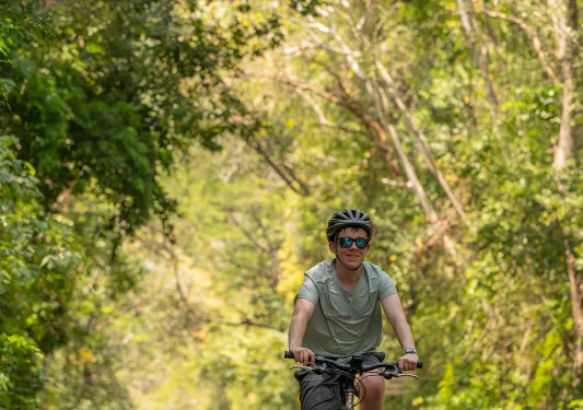 Man with sunglasses biking on the road