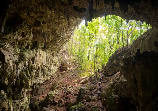 Group of hikers climbing out of a cave