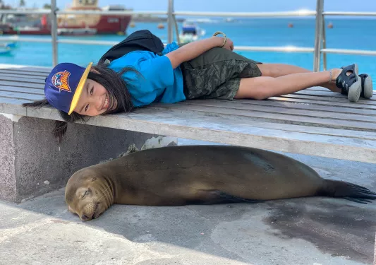 Man lying next to seal