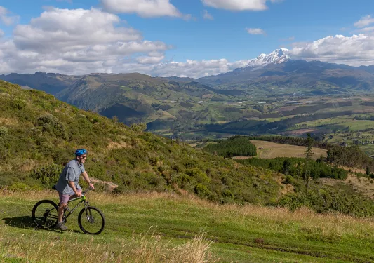 Biker cycling across a large field