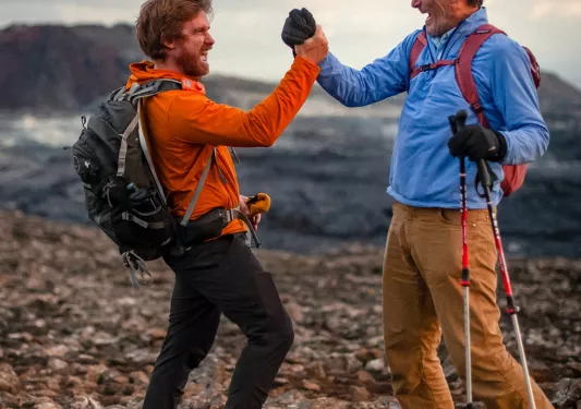 Two hikers shake hands on the trail