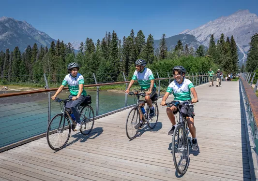 Backroads guests cycling across a bridge