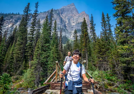 Backroads guest hiking across a bridge