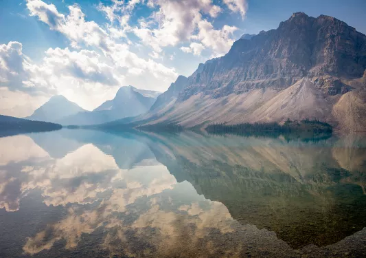 reflective lake next to mountain
