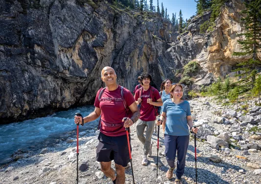 Backroads guests hiking next to a creek