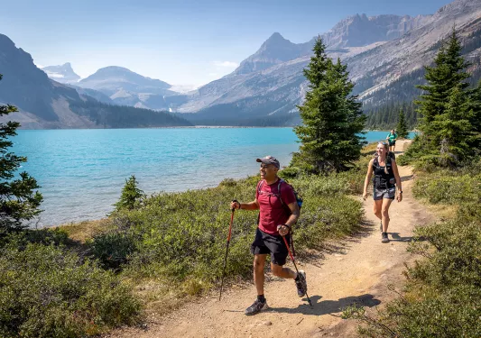 hikers walking by a lake