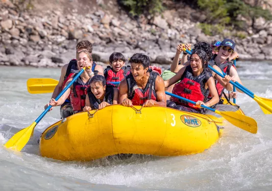 teens on a raft in the river