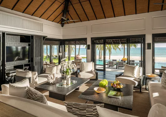 large living room with couches surrounding coffee tables