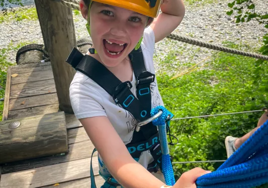 A child prepares to zipline