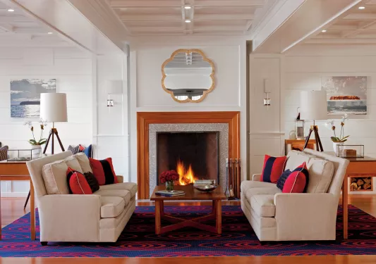 Hotel lobby with a stone fireplace and art on the walls