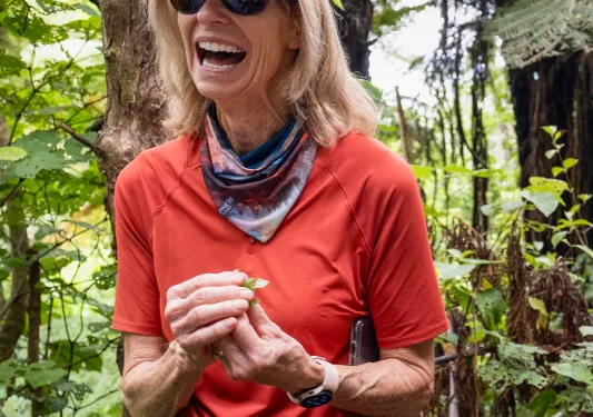 Woman laughing while holding plants in her hand