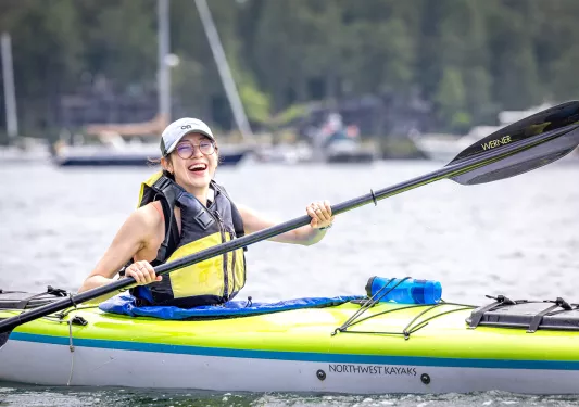 Woman paddling on a kayak in a lake