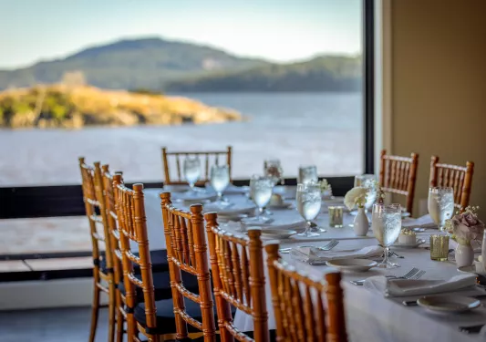 long dining room table with a view of the water