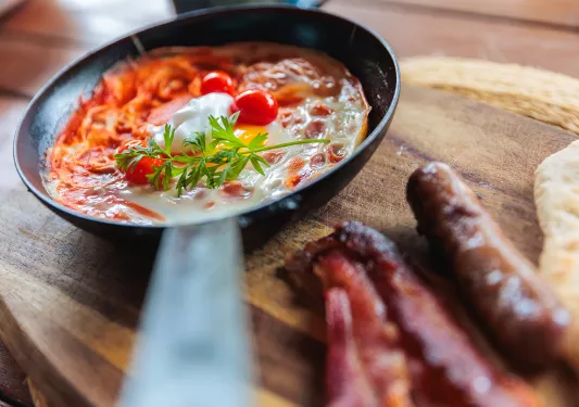 A bowl of food on a wooden board