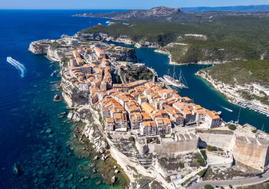 Sky view of a small town on a small peninsula surrounded by cliffs