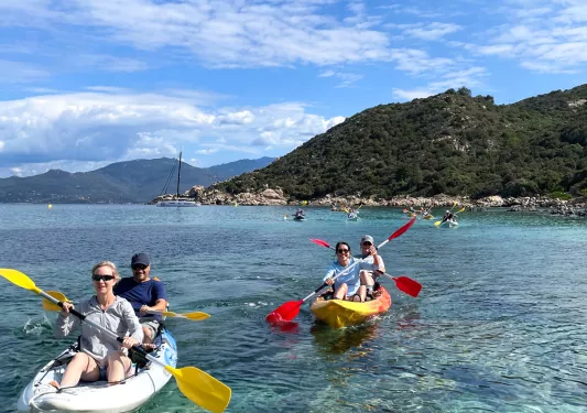 Group on men and woman paddling in two person kayaks
