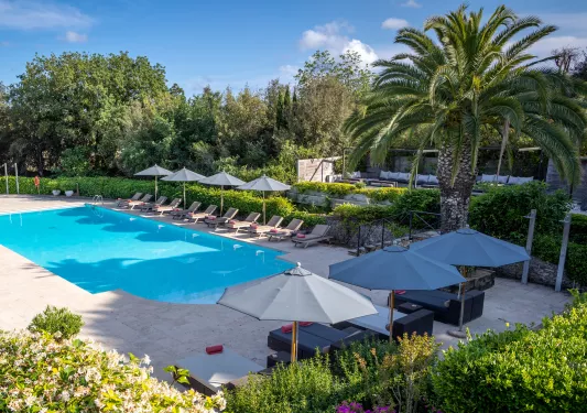 Swimming pool surrounded by lounge chairs