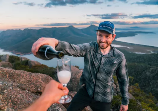 Man pouring alcohol into a small glass