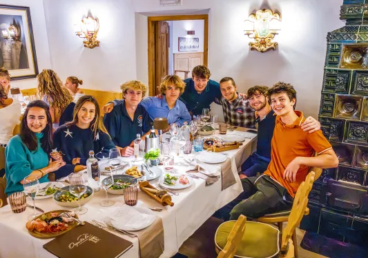 Group of men and women around a dining table