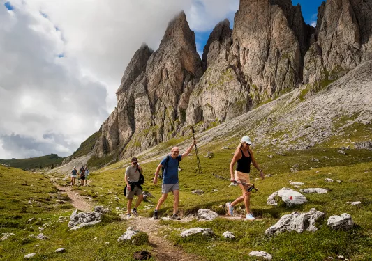 Hikers walking up a path near mountains