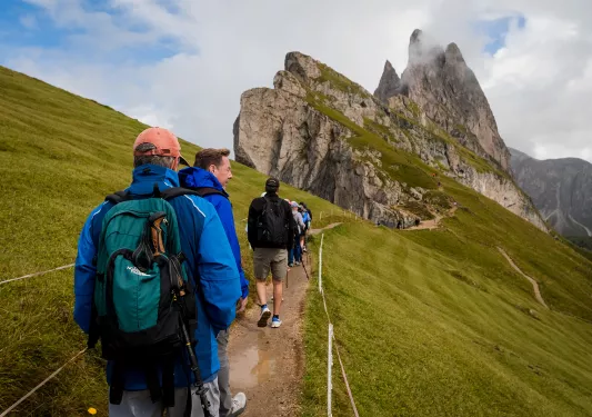 Hikers walking trail towards mountain