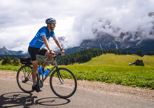 Man wearing sunglasses and riding a bike 