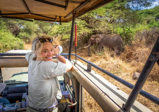 a guest takes a photo on safari