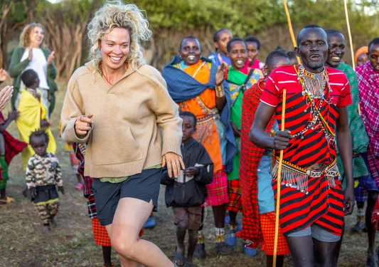 a guest dances with local group