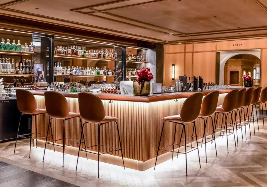 Bar with cushioned bar stools along the perimeter