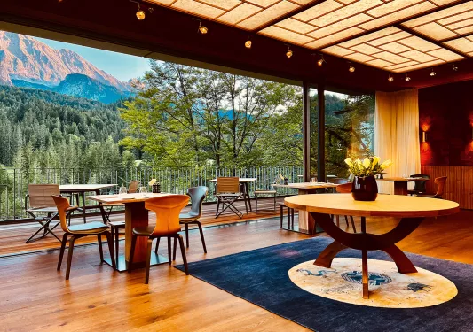 Dining room tables overlooking trees on a mountainside