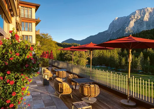 Courtyard tables and chairs overlooking a grass field