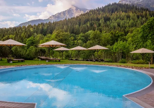 Large swimming pool surrounded by sun umbrellas
