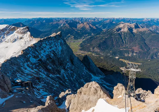 Electrical tower on a snowy, rocky mountain
