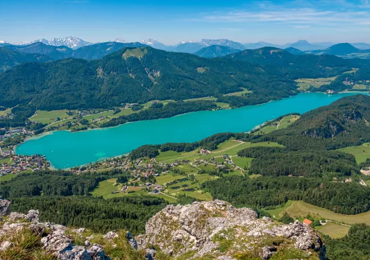 a blue lake surrounded by rolling mountains