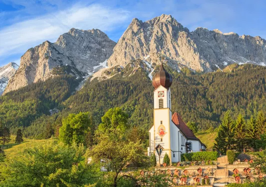 Church building with grassy mountain in the foreground