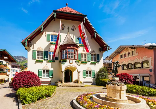 a traditional home surrounded by flower beds