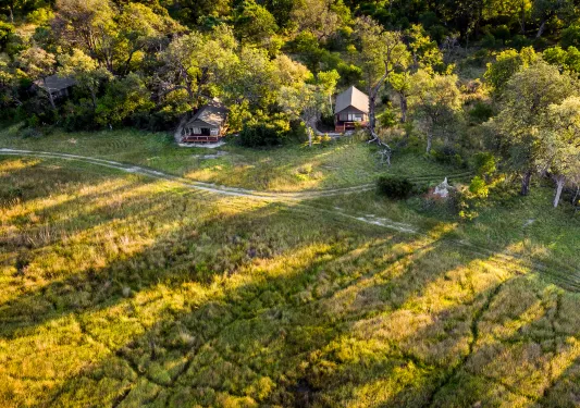 grassy fields with small cottages