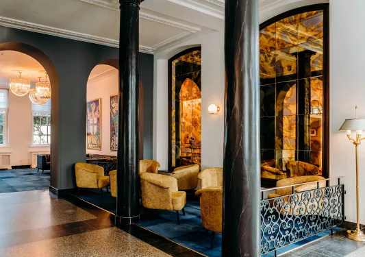 Couches in lobby with two black pillars