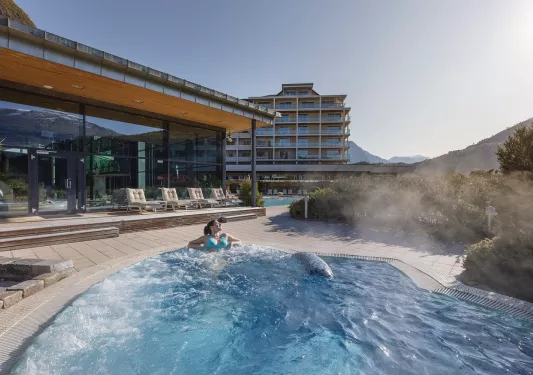 Women in a bubbling hot tub looking out to the mountains