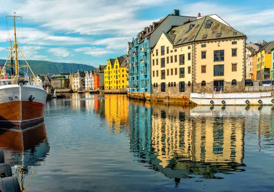 River in between tall houses in a town