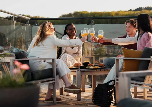 friends cheers wine glasses on a patio