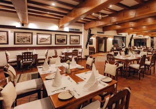 Dining hall with wooden walls and folded handkerchiefs on each table
