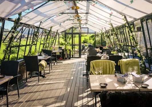 Outdoor dining area, covered with white tarps and vinyl flooring