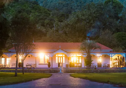 Lights coming out of a hotel building with a tall mountain behind it