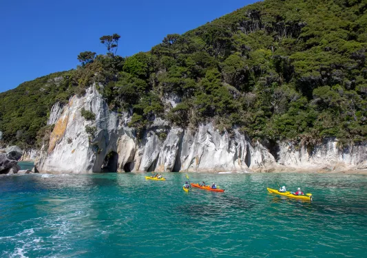 Four kayaks full of people paddling