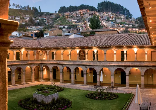 lit up hotel surrounded by houses