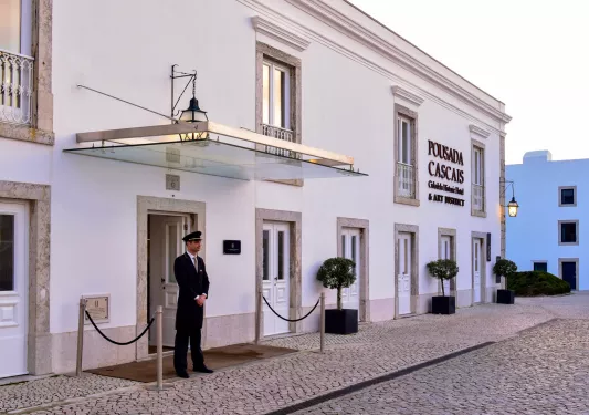 doorman outside the entrance to the citedela de cascais