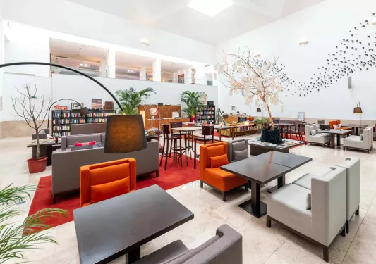 lobby with bookshelves and chairs and couches