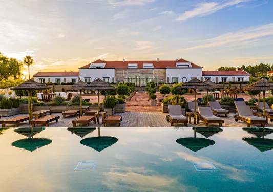 Front view of hotel with an infinity pool in front